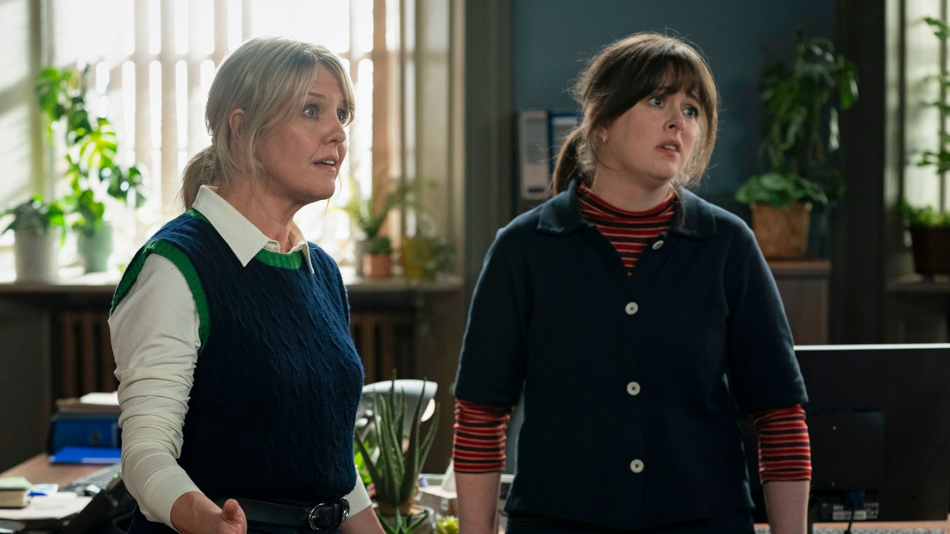 two women standing in office