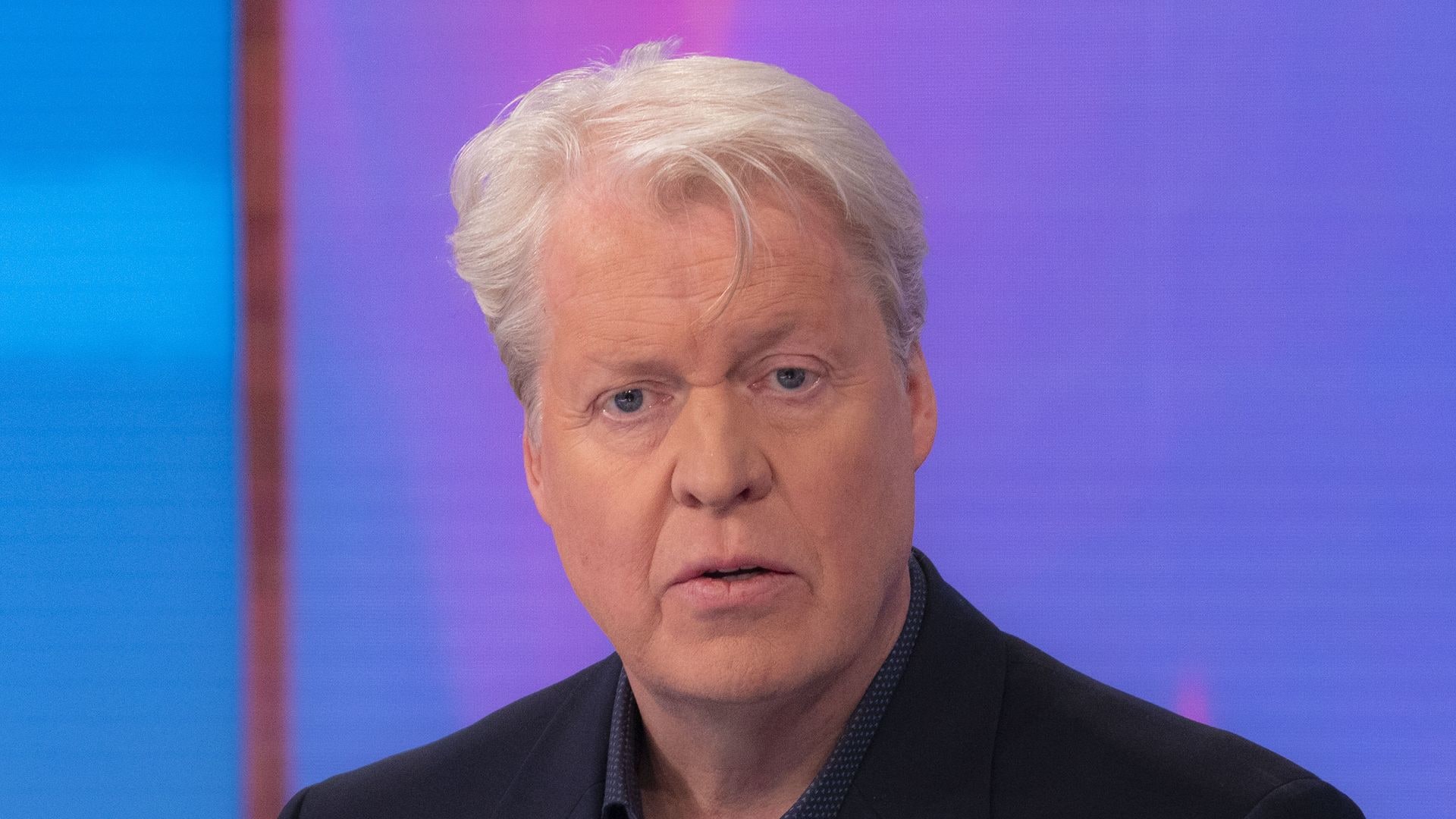 Charles Spencer in a black suit jacket