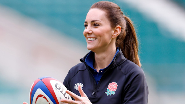 Kate in sports gear throwing rugby ball