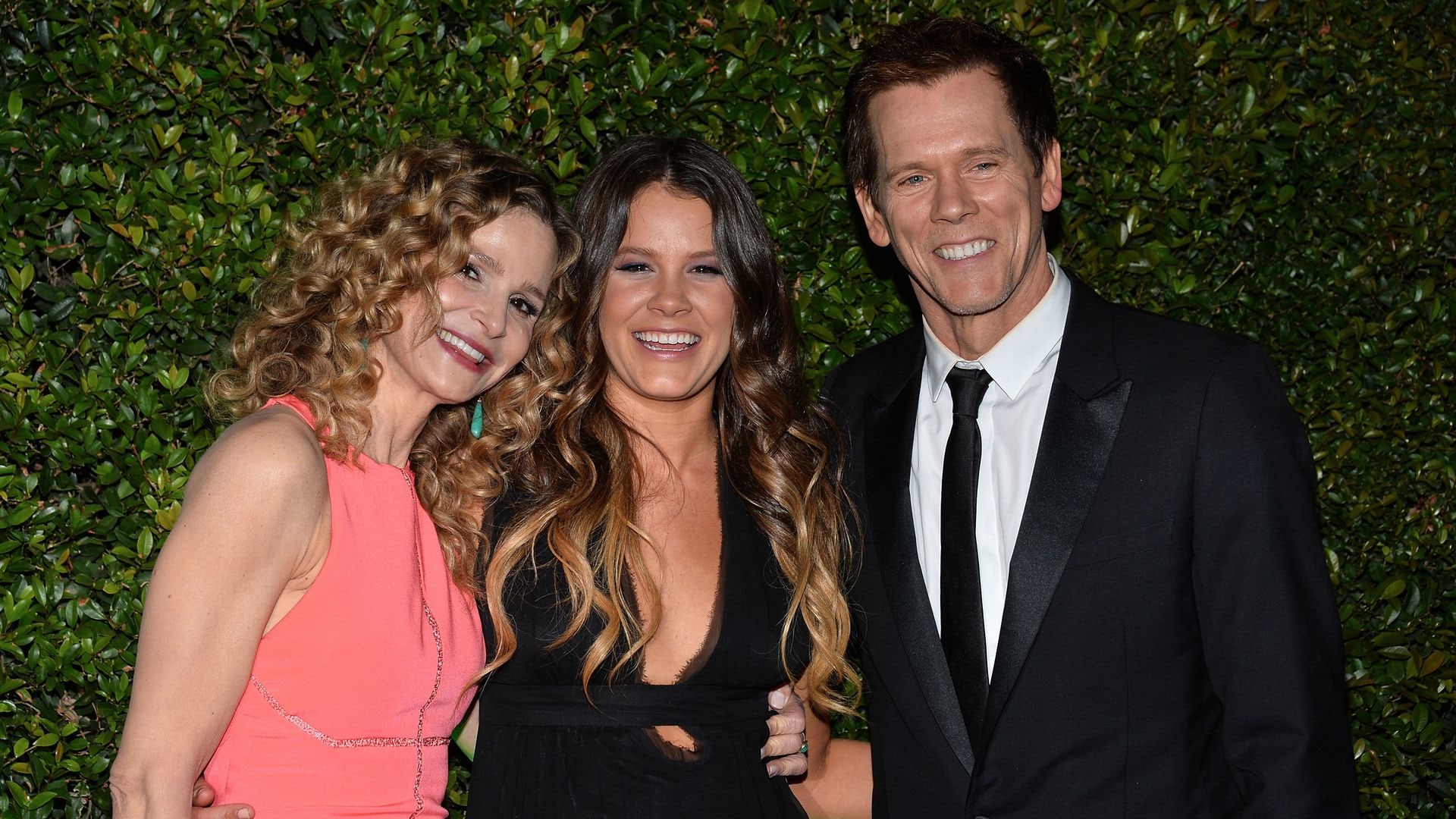 Kevin, Sosie and Kyra smiling wide on the red carpet for a party in 2014