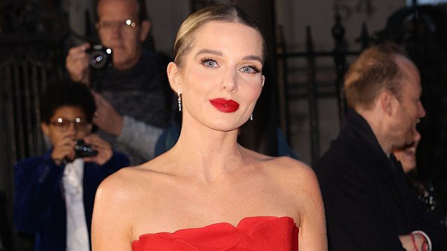 Helen Flanagan standing in a red mini-dress