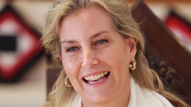 Duchess Sophie with wavy hair smiling in a white scarf