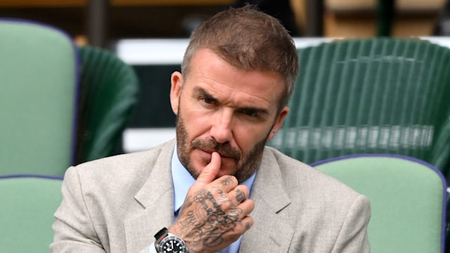 David Beckham looking straight ahead to the camera while sitting in the royal box of Wimbledon