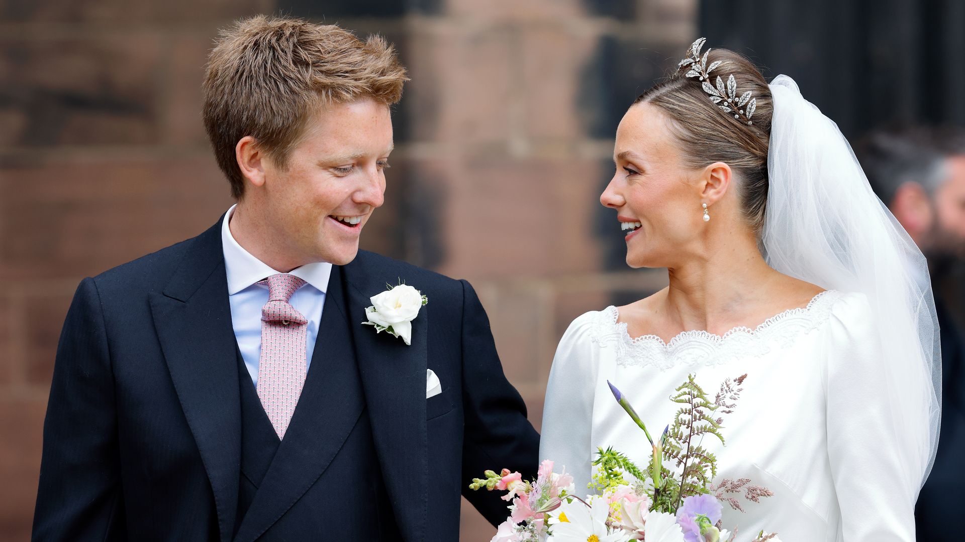 Duke and Duchess of Westminster smiling at each other after wedding
