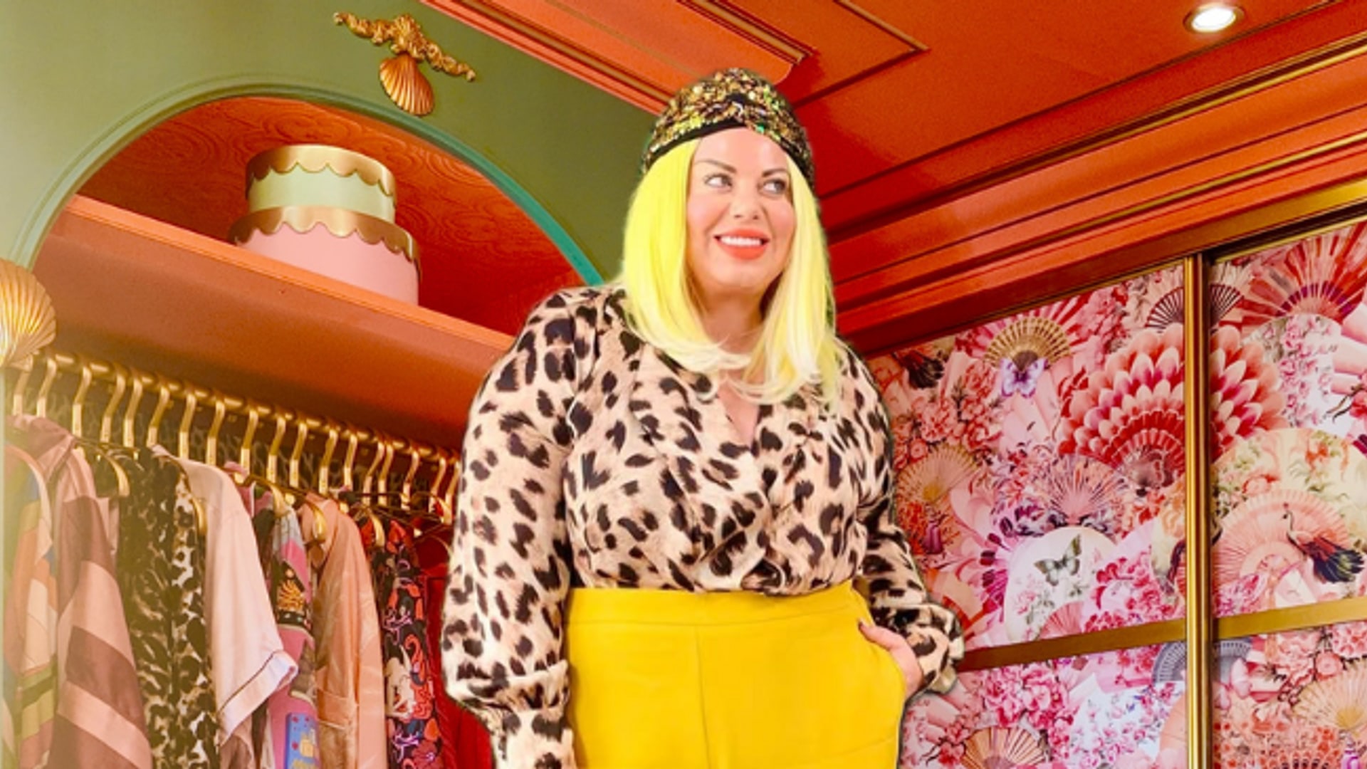 woman with leopard print top in front of bright dressing room