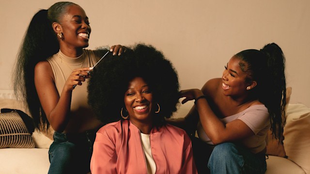 Jamelia smiling sitting on the floor