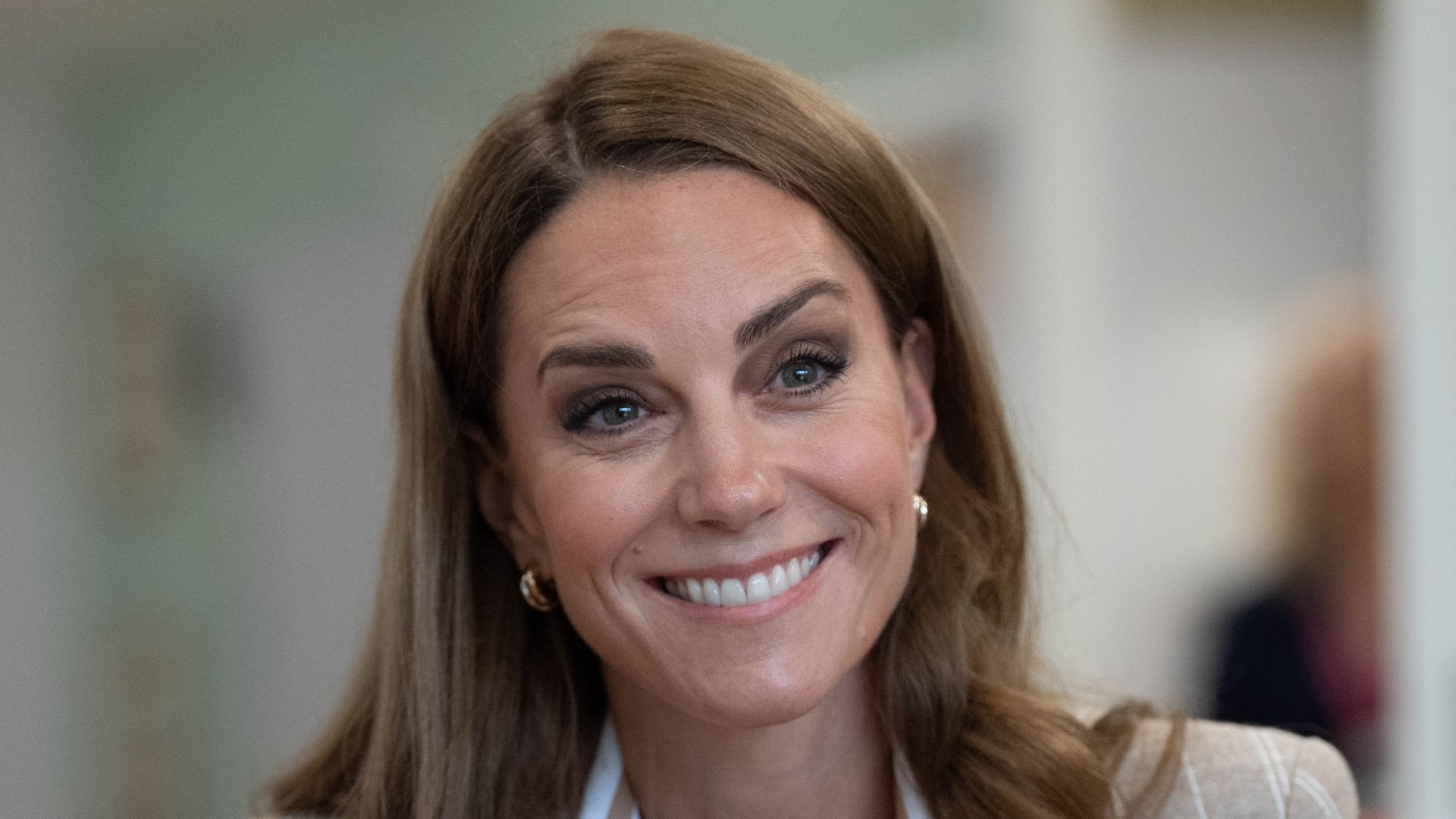 Catherine, Princess of Wales smiles in striped tan blazer