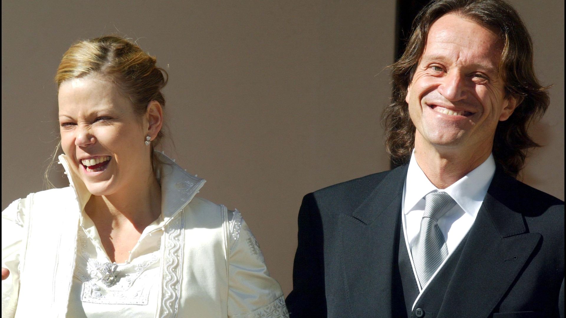 Princess Kalina in a white wedding dress smiling with her husband Kitin