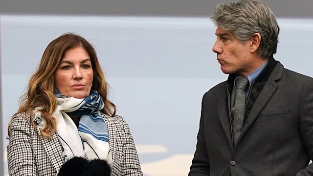 Karren Brady in a coat standing next to Paul Peschisolido