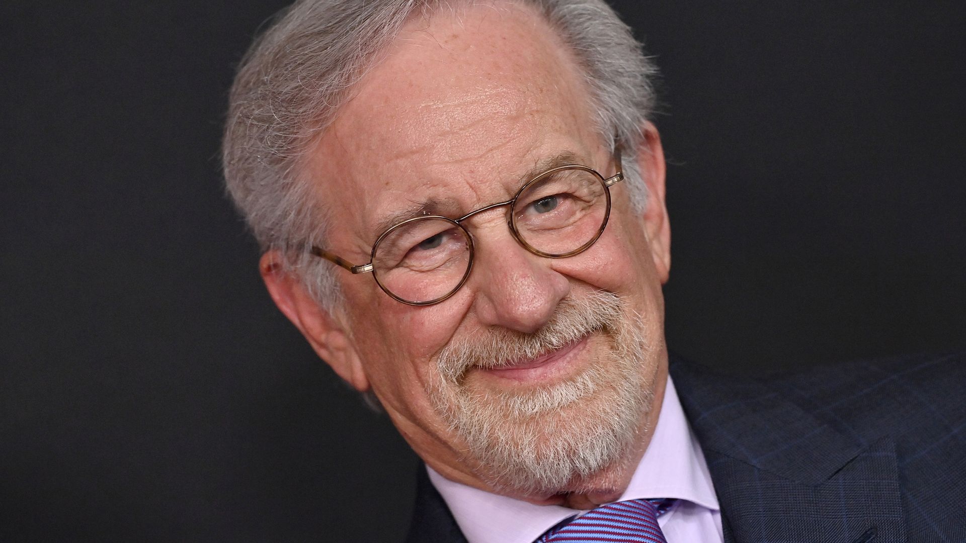 Steven Spielberg smiling at an event photo call
