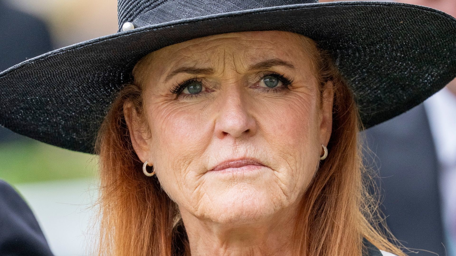 Sarah Ferguson in a polka dot dress and hat looking sad