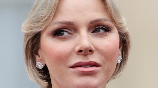 Princess Charlene close looking sideways in white jumpsuit