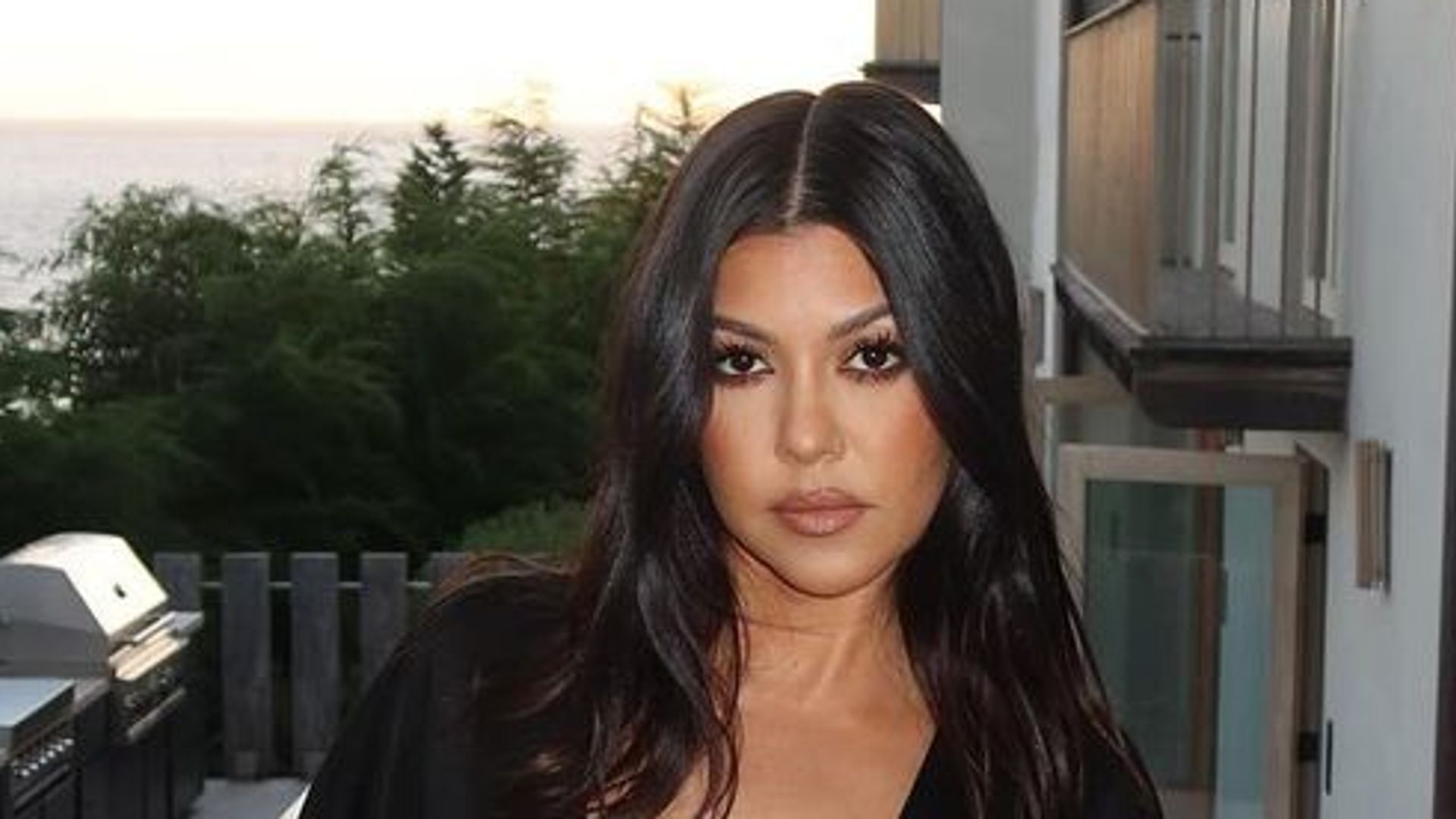 Kourtney Kardashian stuns in Morticia-inspired plunging black dress with her eerie early Halloween decor in $10m LA home