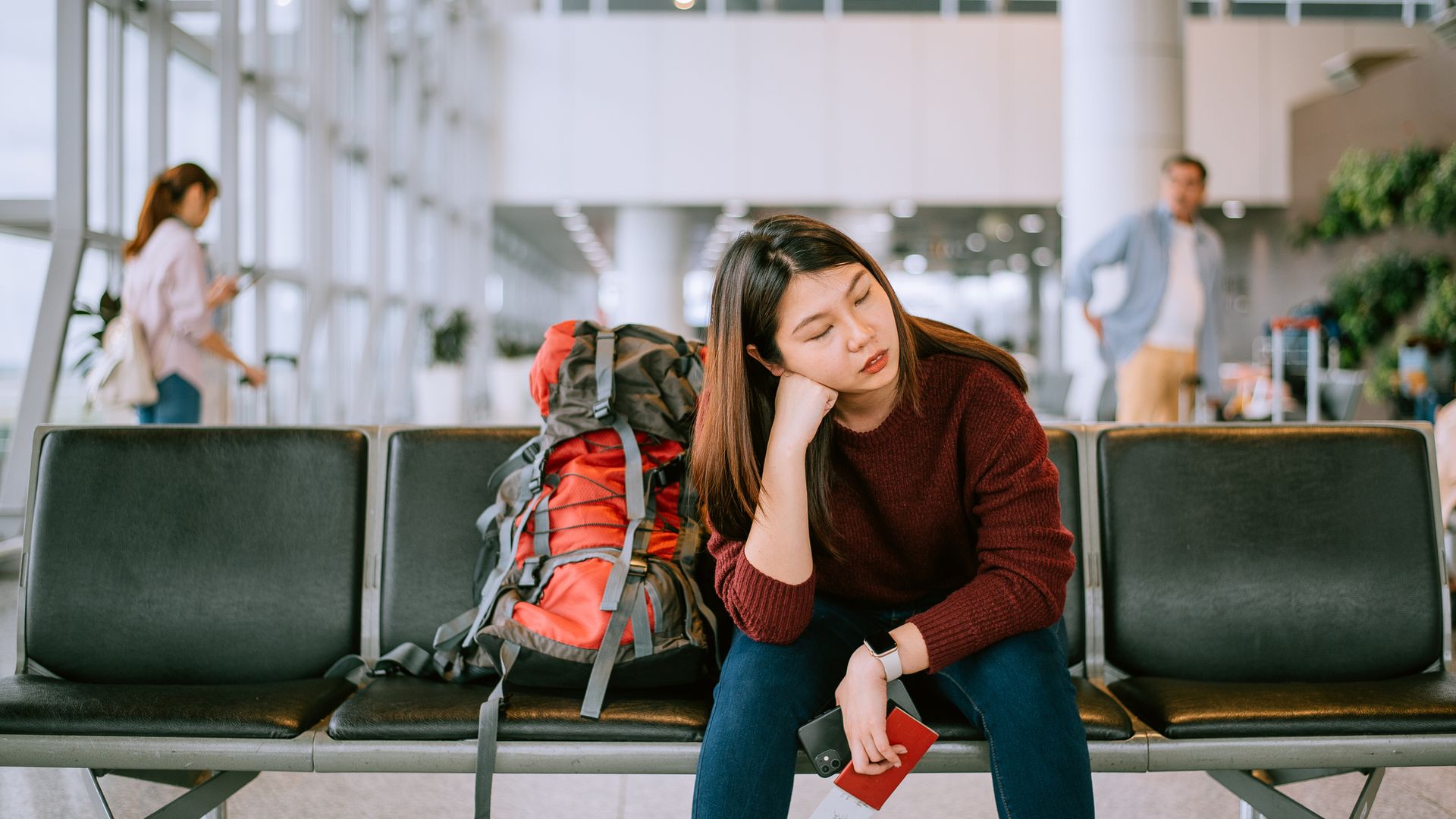 Upset girl traveling along waiting for the next flight