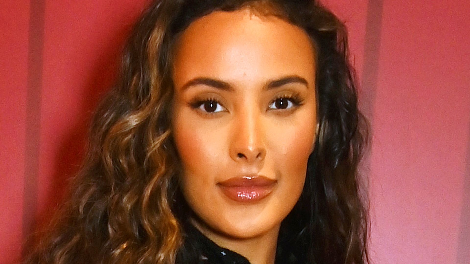 Maya Jama with glowing makeup and lighter hair at Rimmel London event