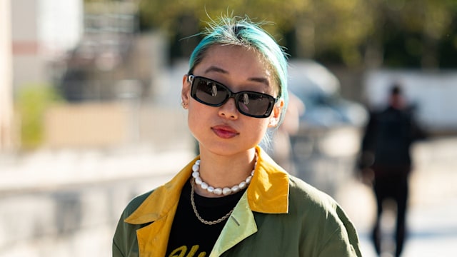 Margaret Zhang wears a black top, green printed jacket, black long skirt with fur details, outside Balenciaga, during the Womenswear Spring/Summer 2024 as part of  Paris Fashion Week on October 01, 2023