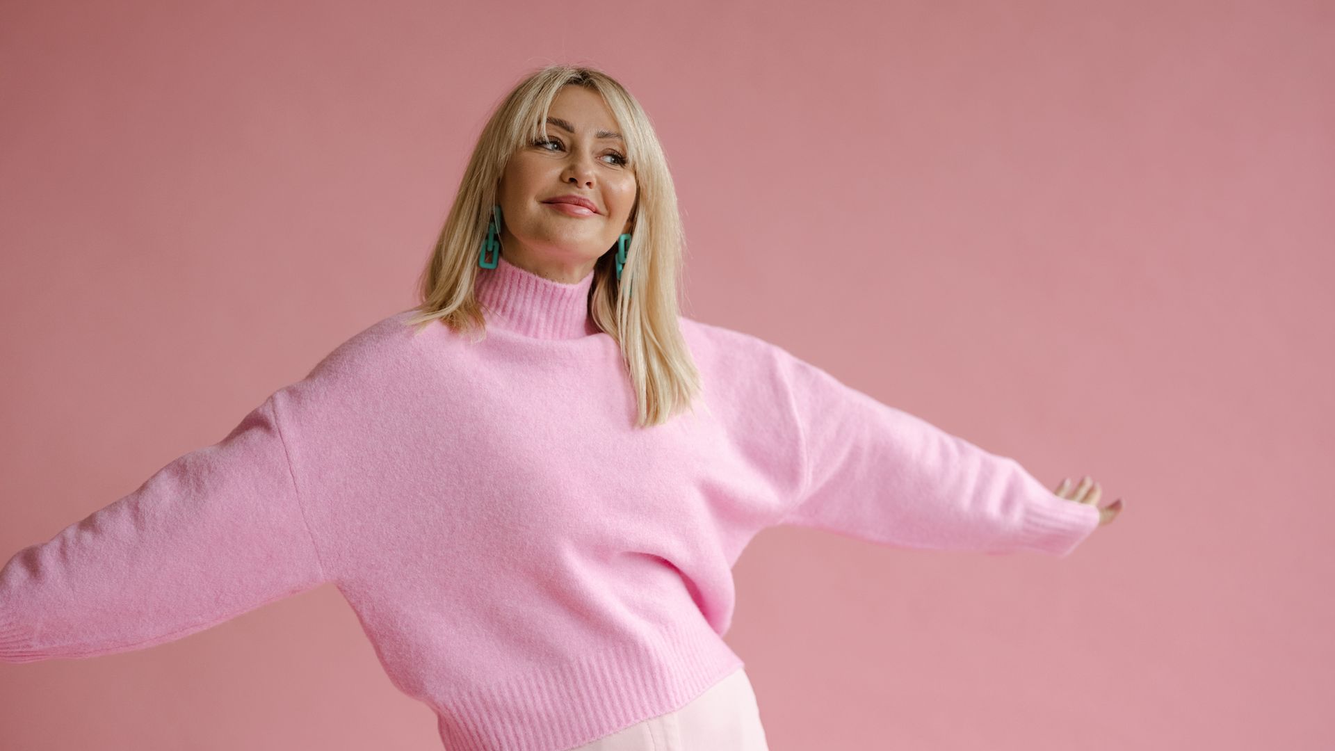 portrait of a happy, confident woman in pink clothes
