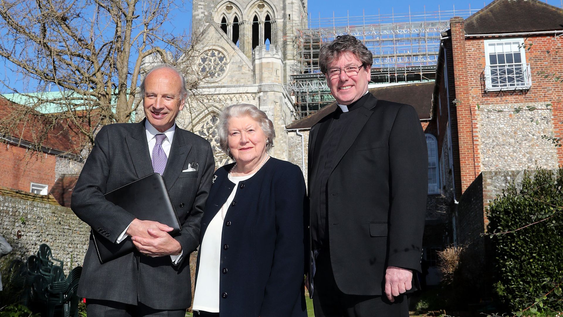 Daniel Hodson (left) Chairman of the High Roof Restoration Appeal, Dame Patricia Routledge, Patron of the appeal, and The Very Reverend Stephen Waine, Dean of Chichester Cathedral standing in front of the Cathedral