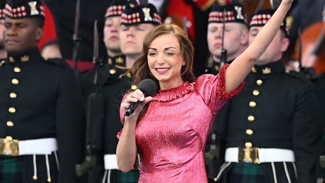 helen george singing on stage in pink dress 