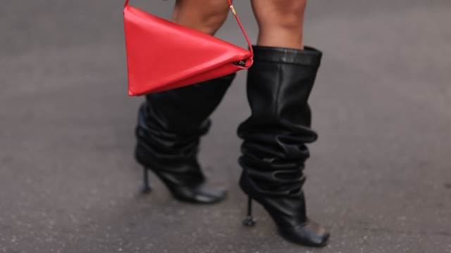 Tiffany Hsu wearing a red triangular bag and black slouchy boots at Paris Fashion Week 