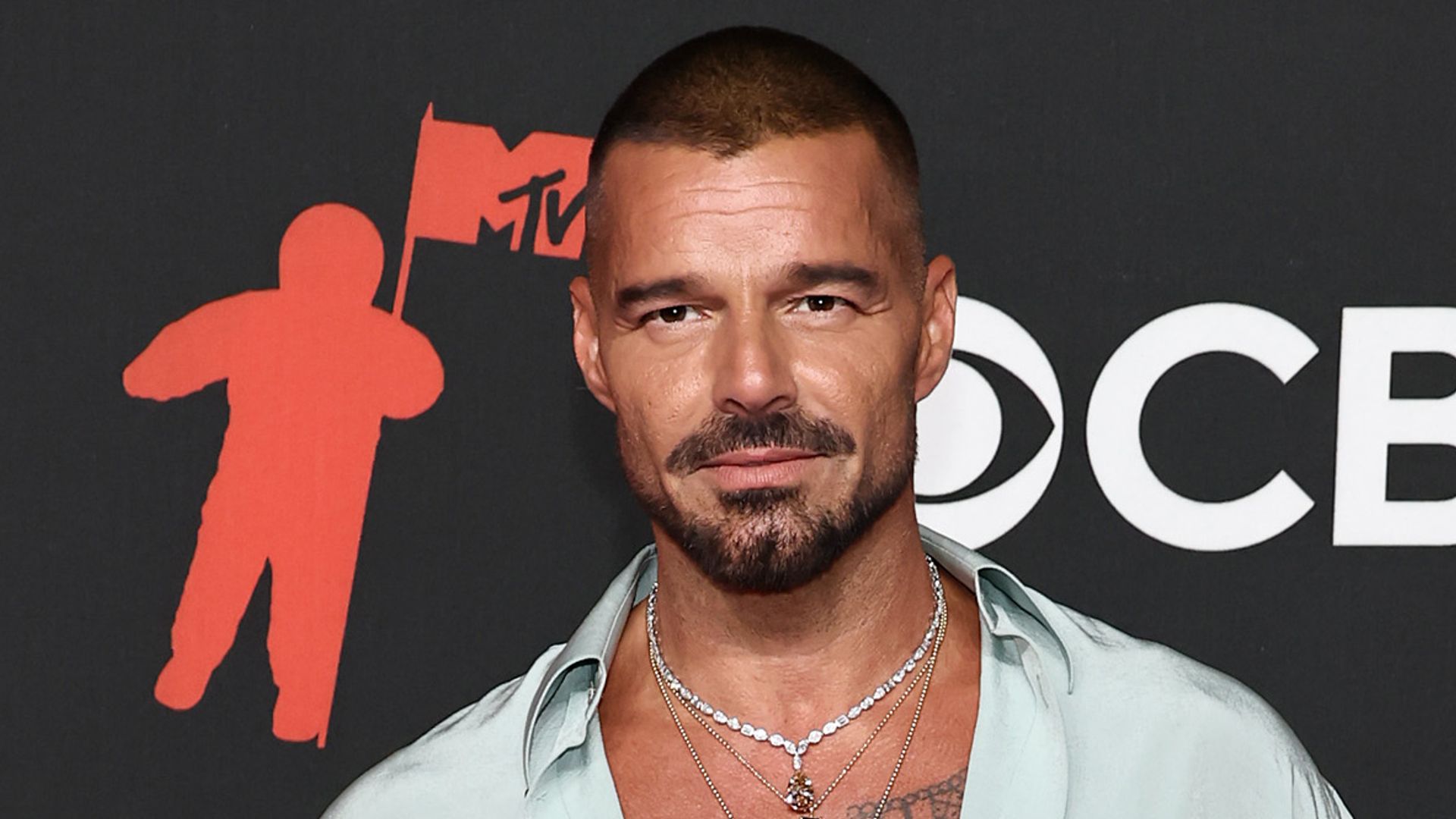 photo of ricky martin wearing unbuttoned shirt on red carpet