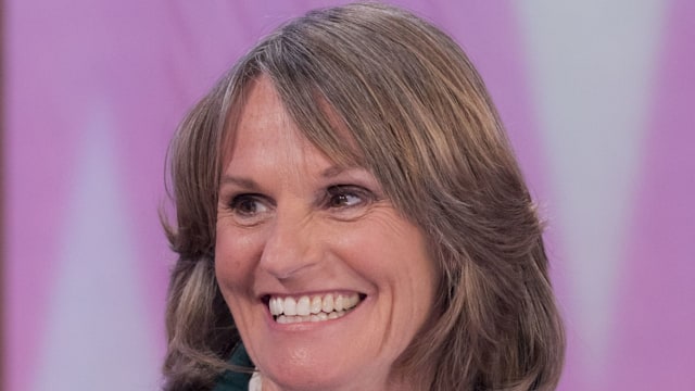 woman smiling in green blazer