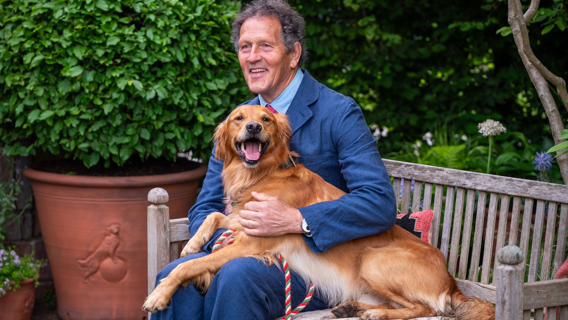 Monty Don sat on a bench with his dog Ned