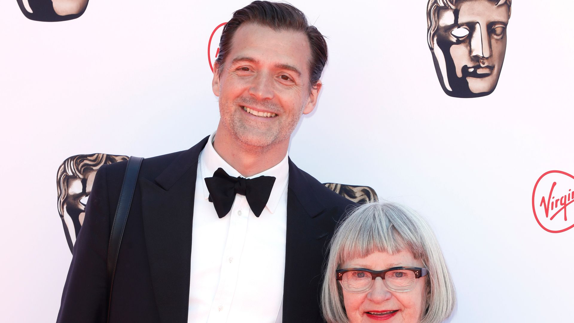 Patrick Grant in a tuxedo with Esme Young in a silver dress