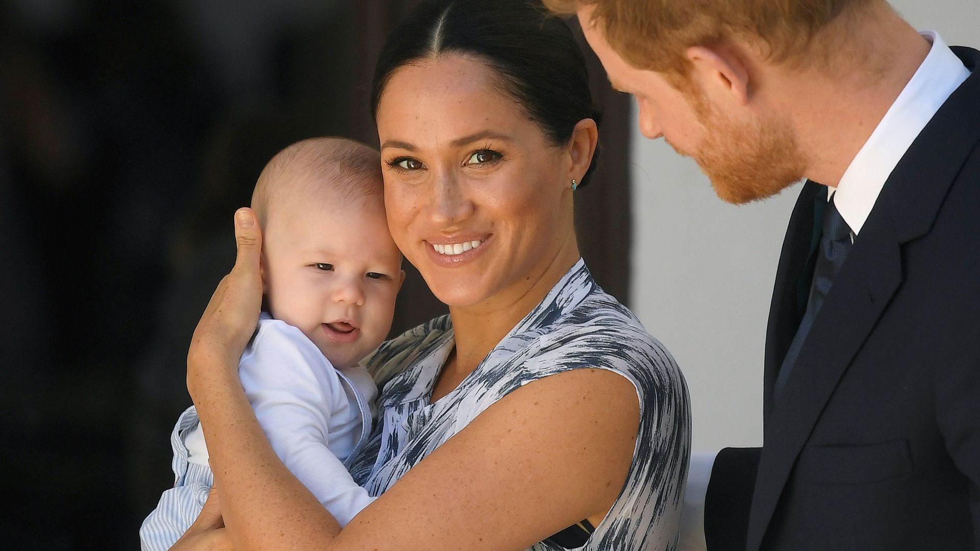 Meghan Markle cradles Archie as Harry looks on with love