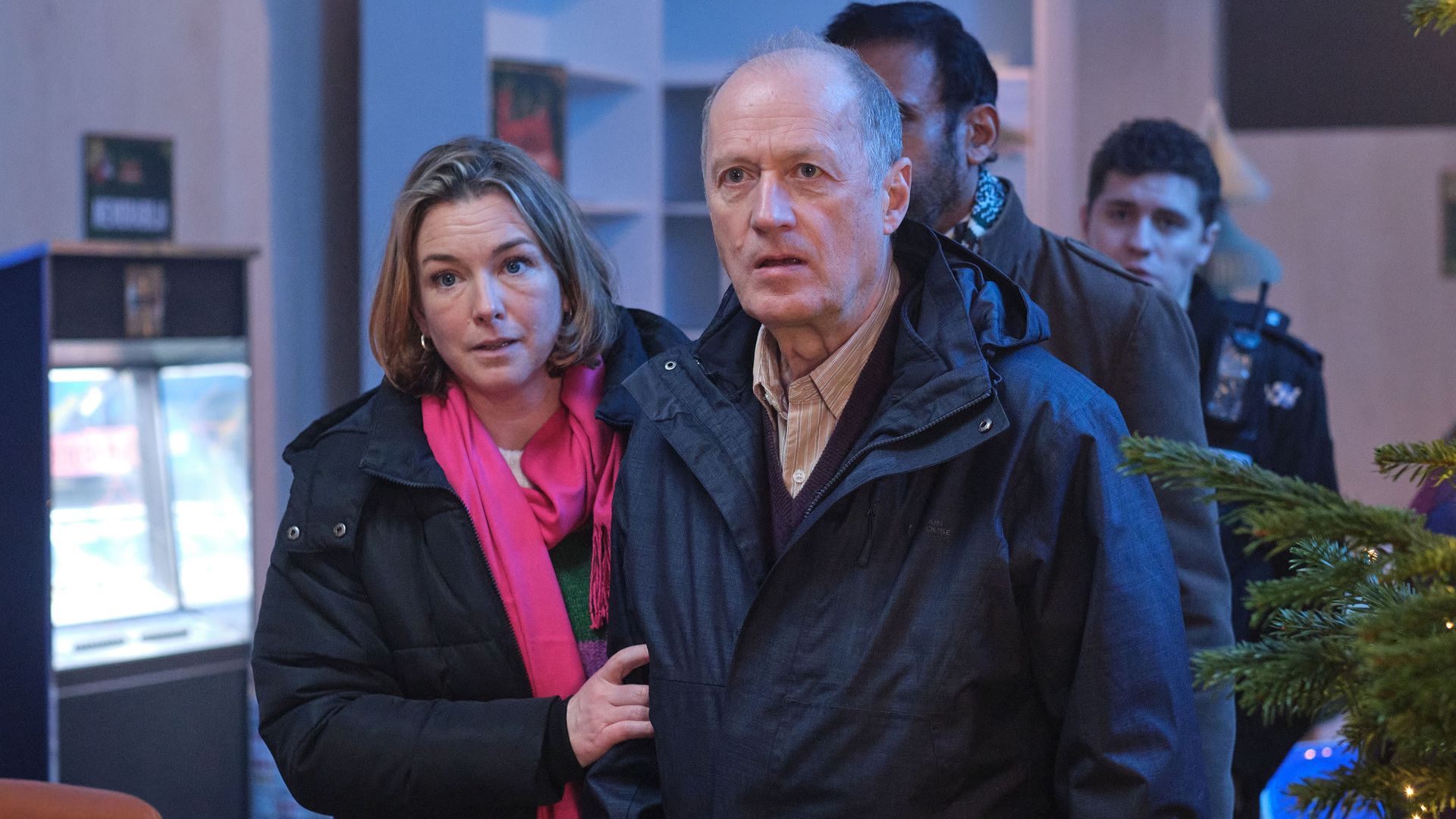 woman and man next to Christmas tree