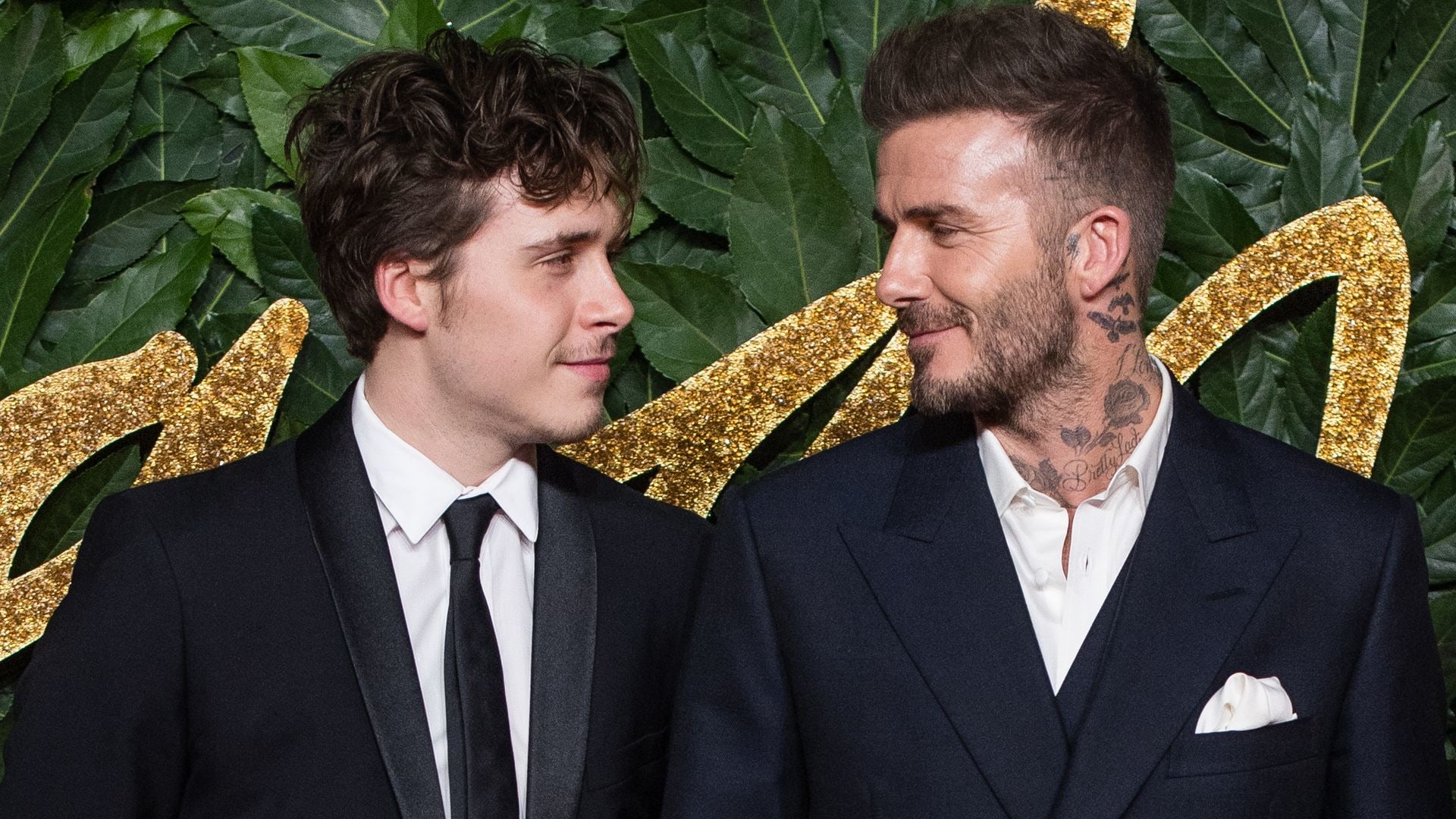 Brooklyn and David Beckham looking at each other