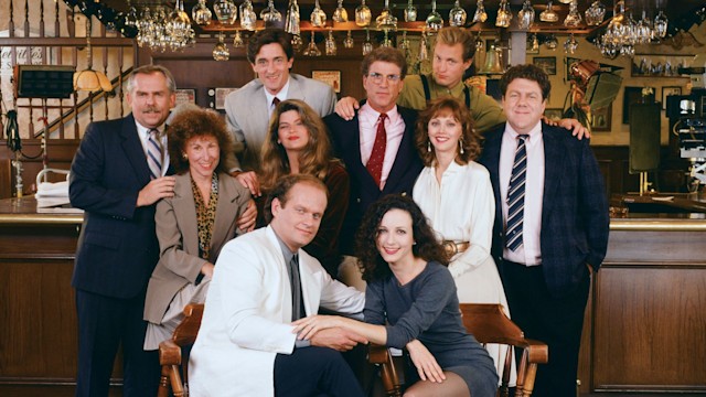 CHEERS -- Pictured: (l-r) John Ratzenberger as Cliff Clavin, Rhea Perlman as Carla LeBec, Roger Rees as Robin Colcord, Kirstie Alley as Rebecca Howe, Kelsey Grammer as Dr. Frasier Crane, Ted Danson as Sam Malone, Bebe Neuwirth as Dr. Lilith Sternin-Crane, Shelley Long as Diane Chambers, Woody Harrelson as Woody Boyd, George Wendt as Norm Peterson