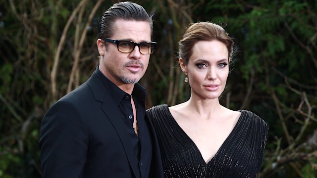 Brad Pitt and Angelina Jolie attend a private reception as costumes and props from Disney's "Maleficent" are exhibited in support of Great Ormond Street Hospital at Kensington Palace in 2014 i