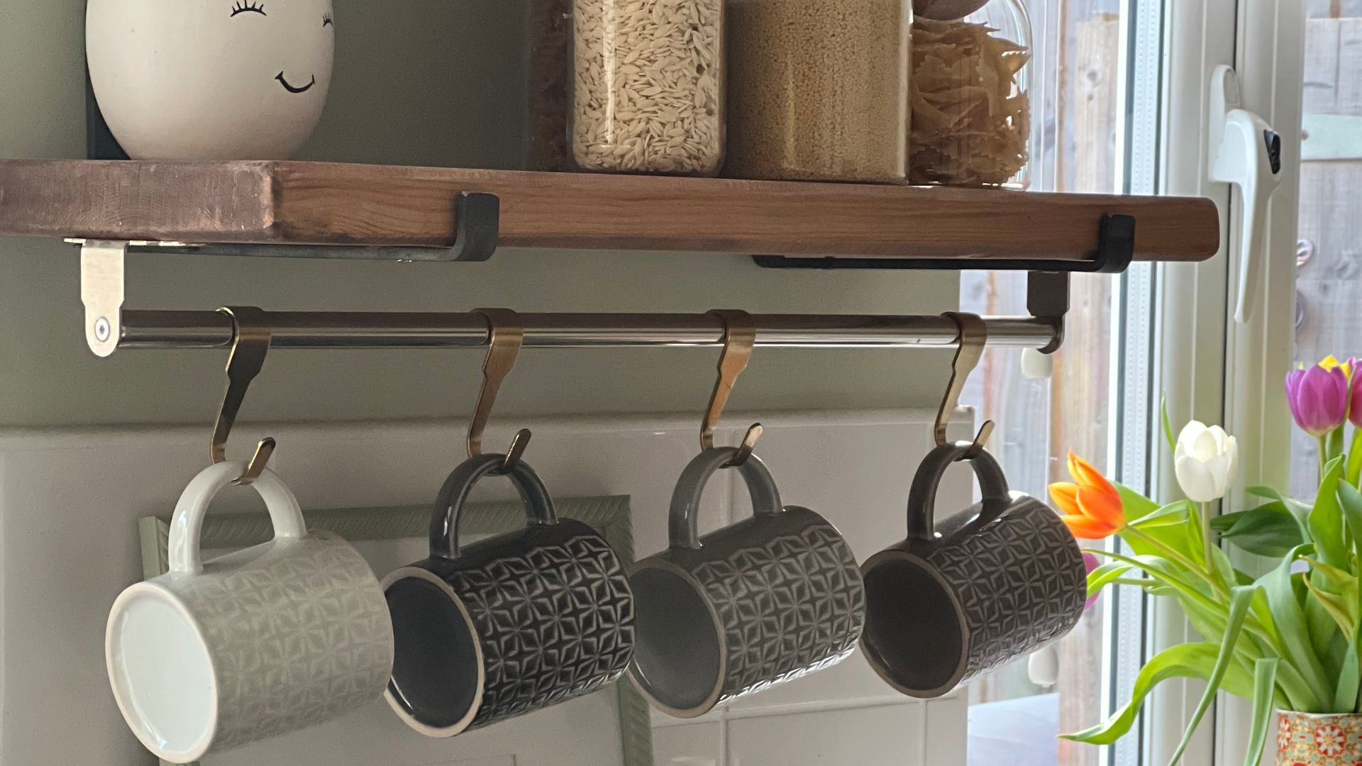kitchen side with shelves cups and kettle