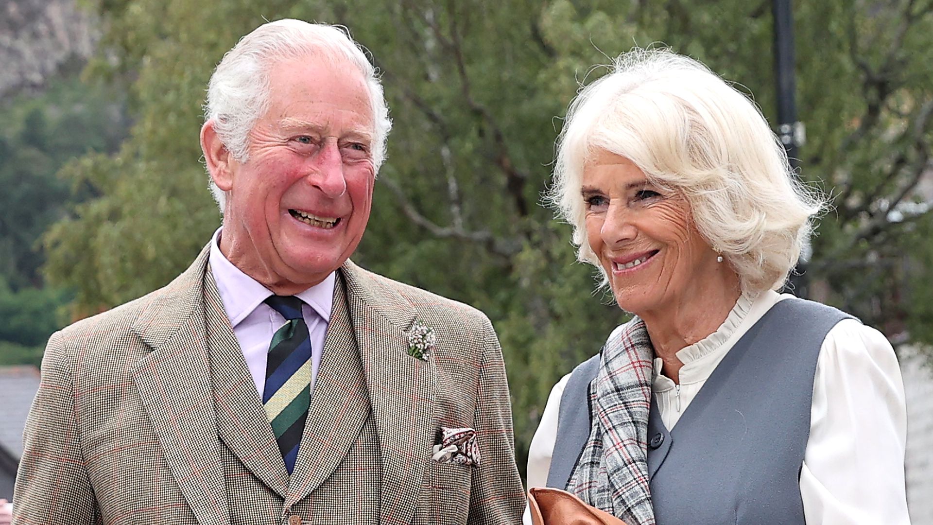 Prince Charles and Camilla smile in tartan dress