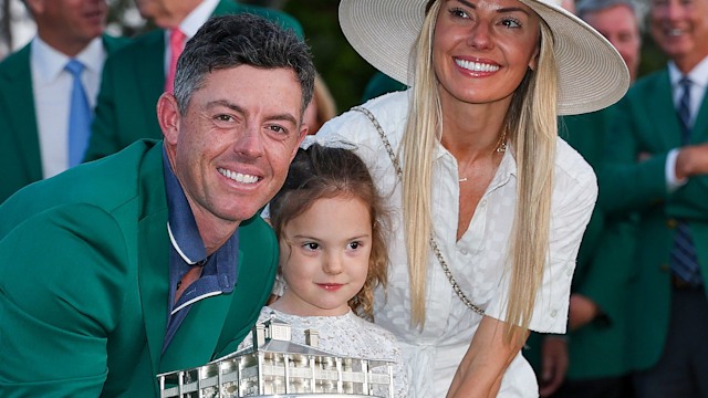 Rory McIlroy of Northern Ireland poses with daughter Poppy and wife Erica Stoll holding the Masters trophy during the Green Jacket Ceremony