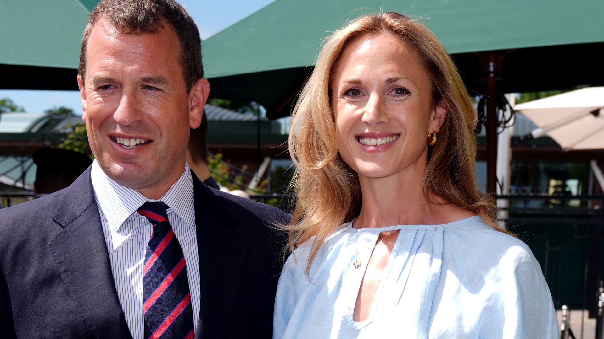 Harriet Sperling at Wimbledon with Peter Phillips wearing a blue chambray outfit from Wiggy Kit and an Aspinal of London handbag