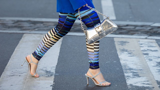 Joicy Muniz wears blue striped leggings with heels 