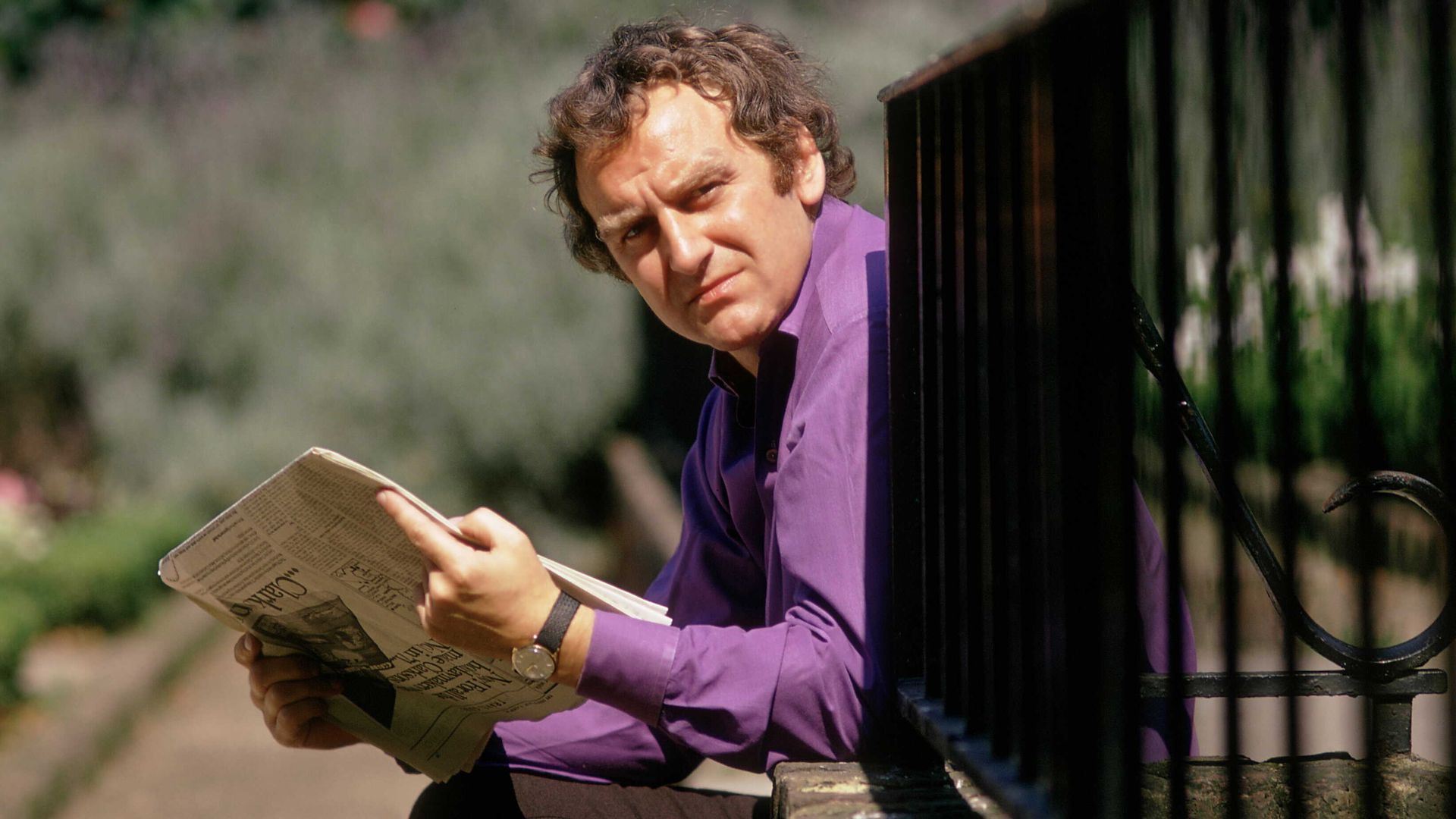 John Thaw holding a newspaper