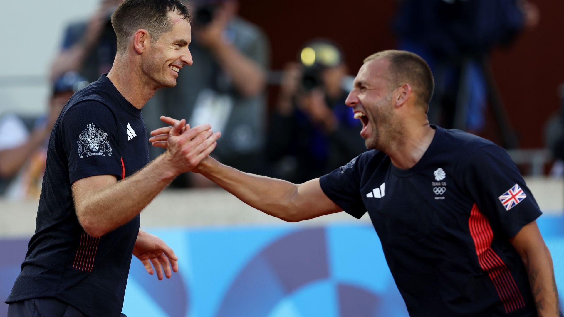 two tennis players celebrating on court