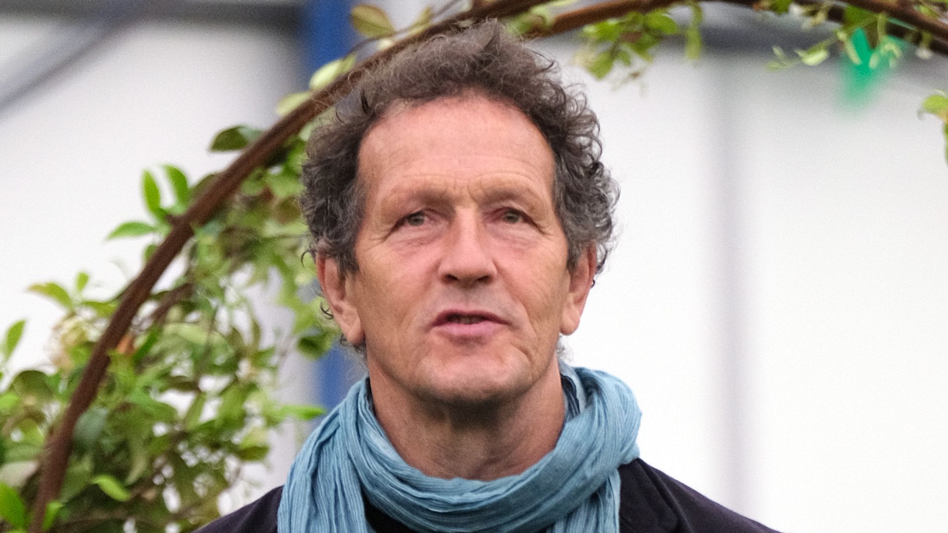 Monty Don with hands up talking outside