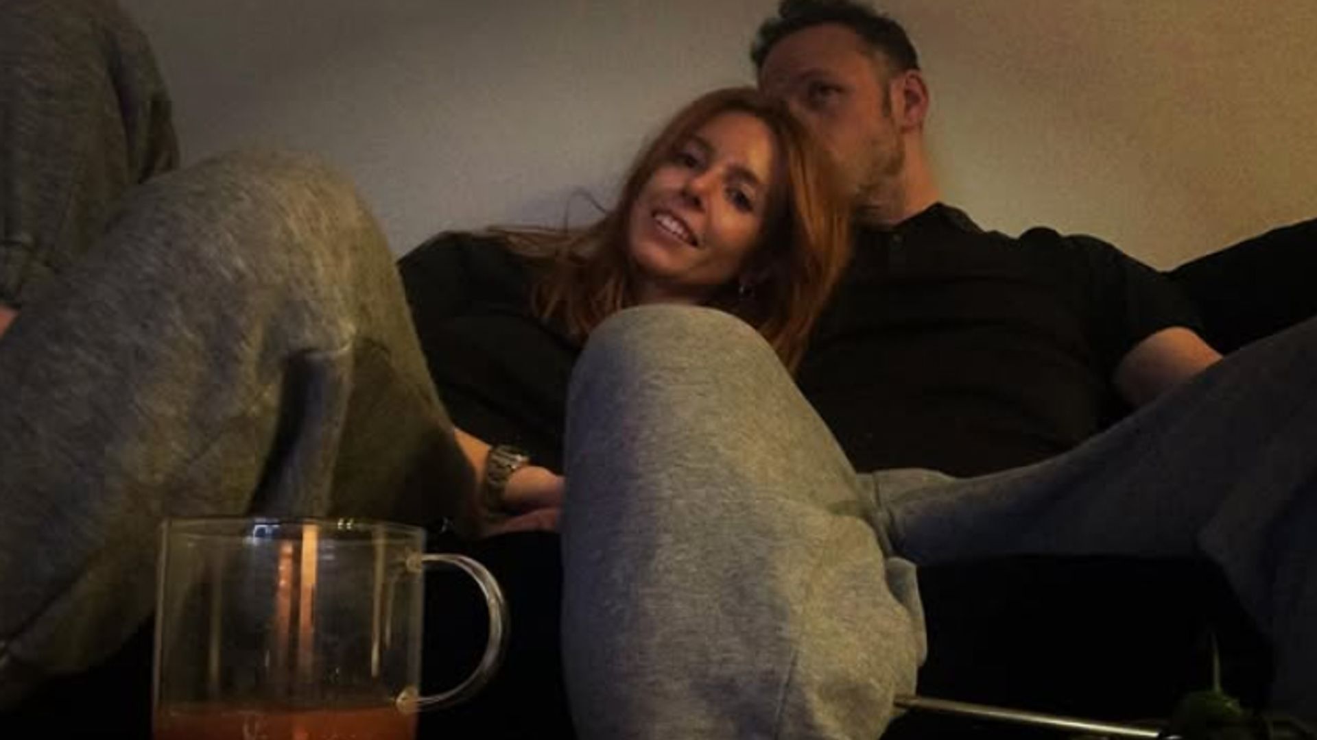 Stacey Dooley being kissed by Kevin Clifton on a sofa