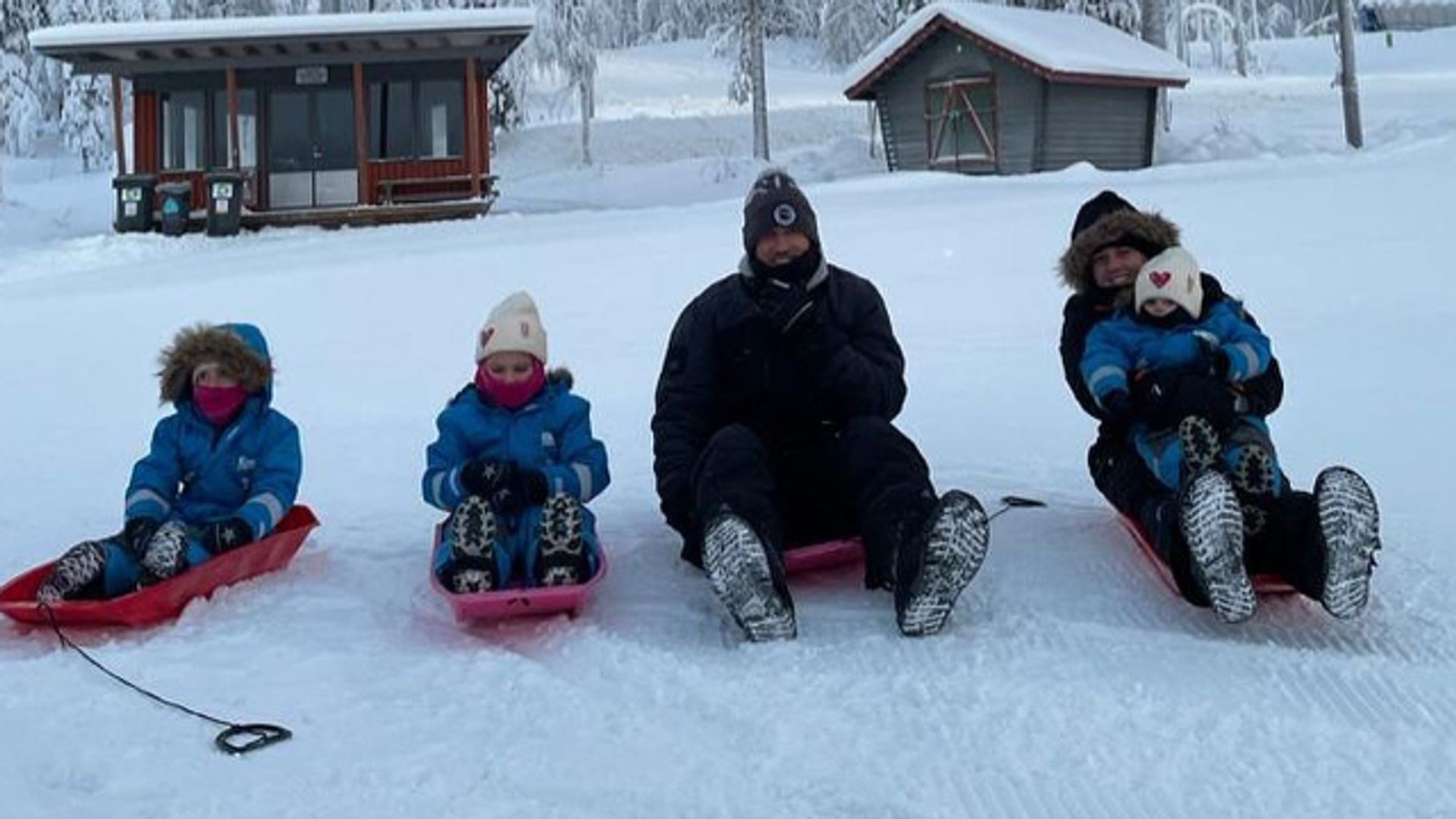 Harry Kane and Kate Kane on sleds with three children