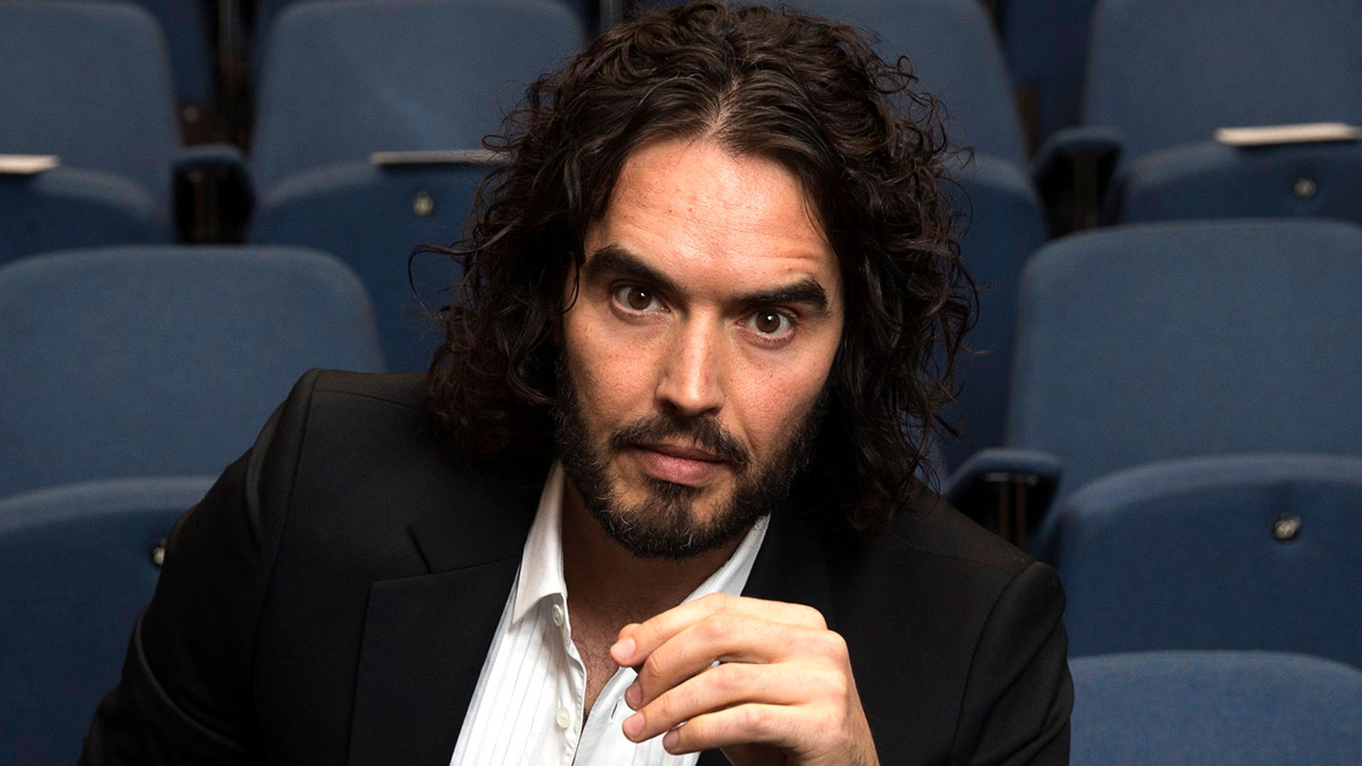 Russell Brand poses for photographs as he arrives to deliver The Reading Agency Lecture at The Institute of Education on November 25, 2014 in London, England. Russell Brand will deliver 'a manifesto on reading' which will be in part personal, sharing his own experience of books and reading while growing up in the UK.  (Photo by Carl Court/Getty Images)