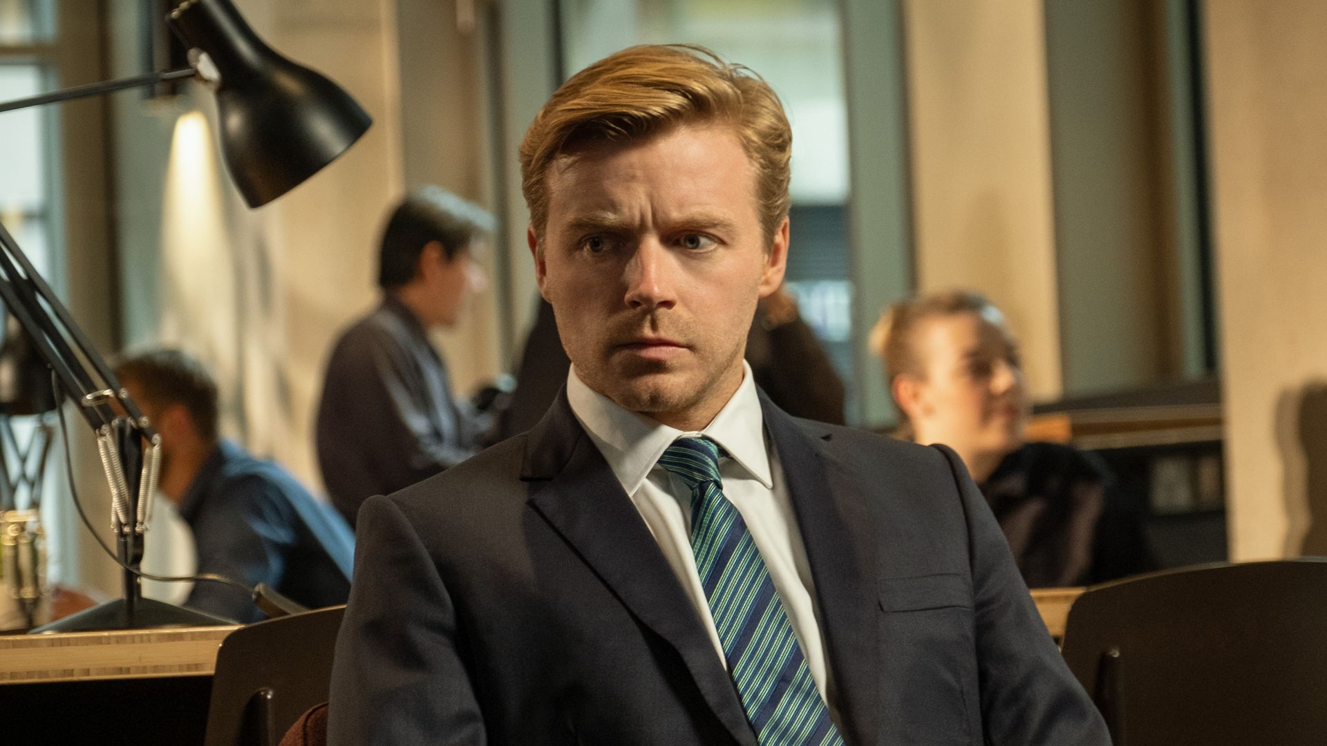 man in suit sitting in office