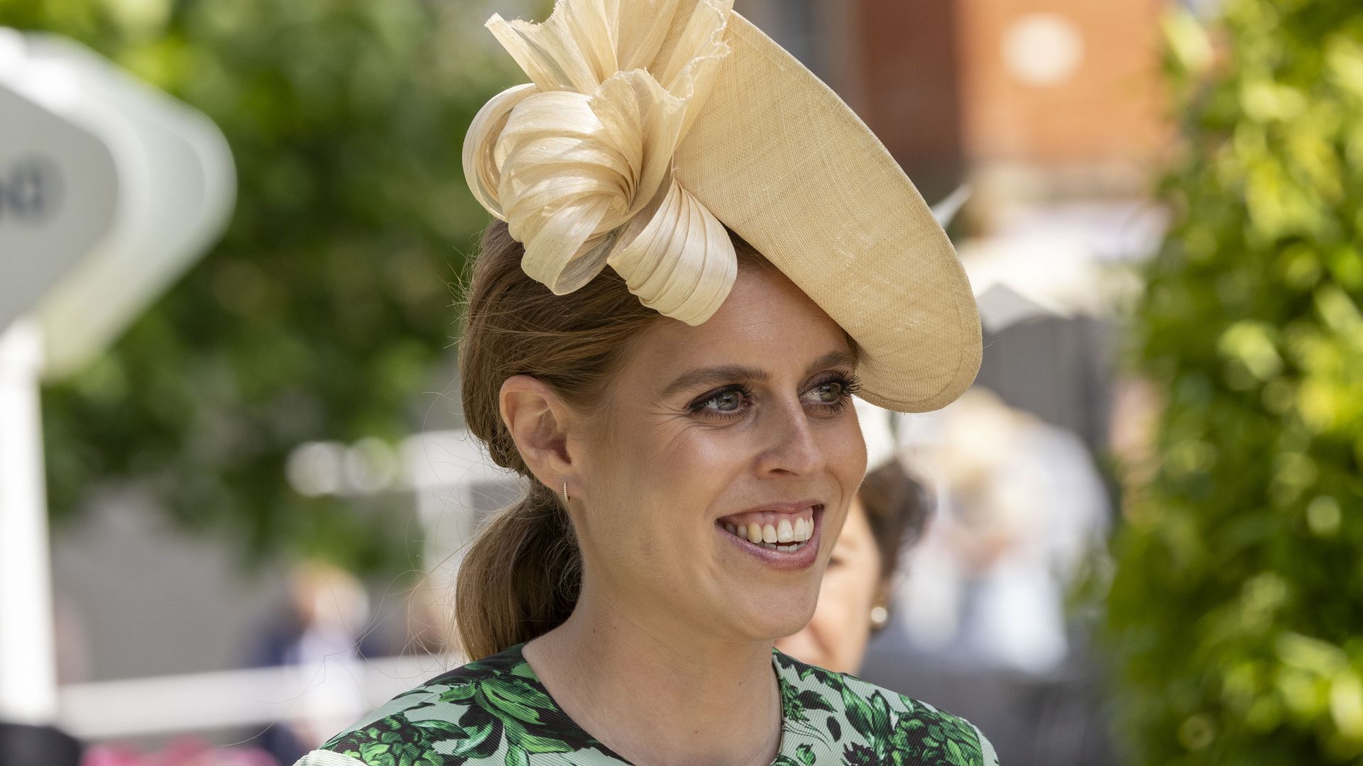 Pregnant Princess Beatrice blooms in floral wedding guest dress and whimsical flower crown