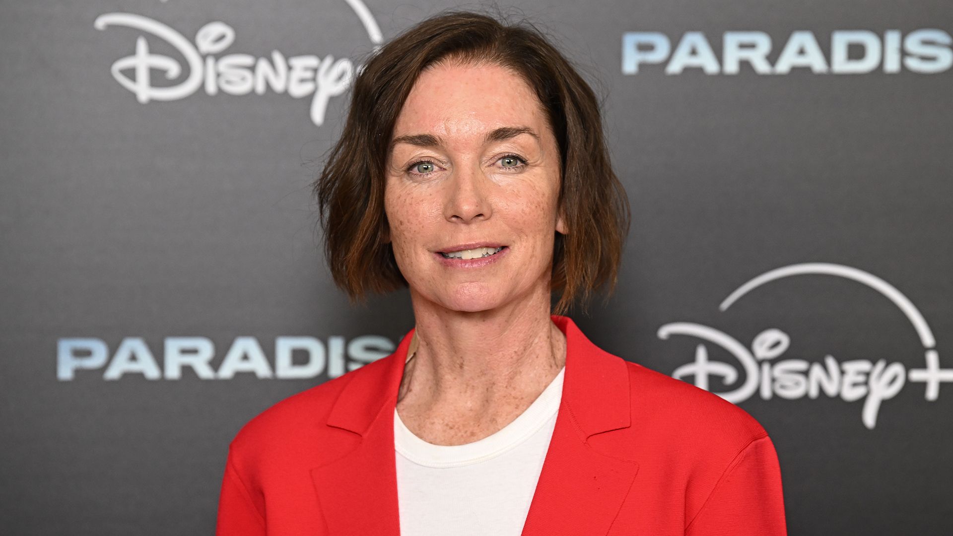 Julianne Nicholson wearing a red blazer and white T-shirt 