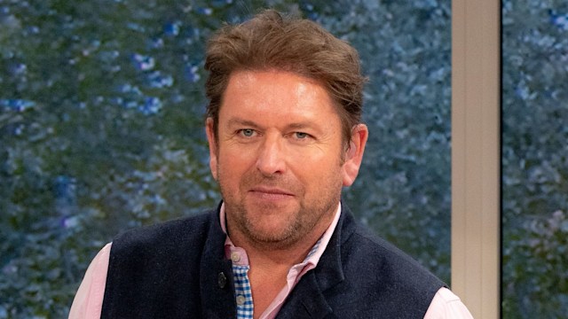 James Martin looking directly at camera with green screen in the background while filming This Morning
