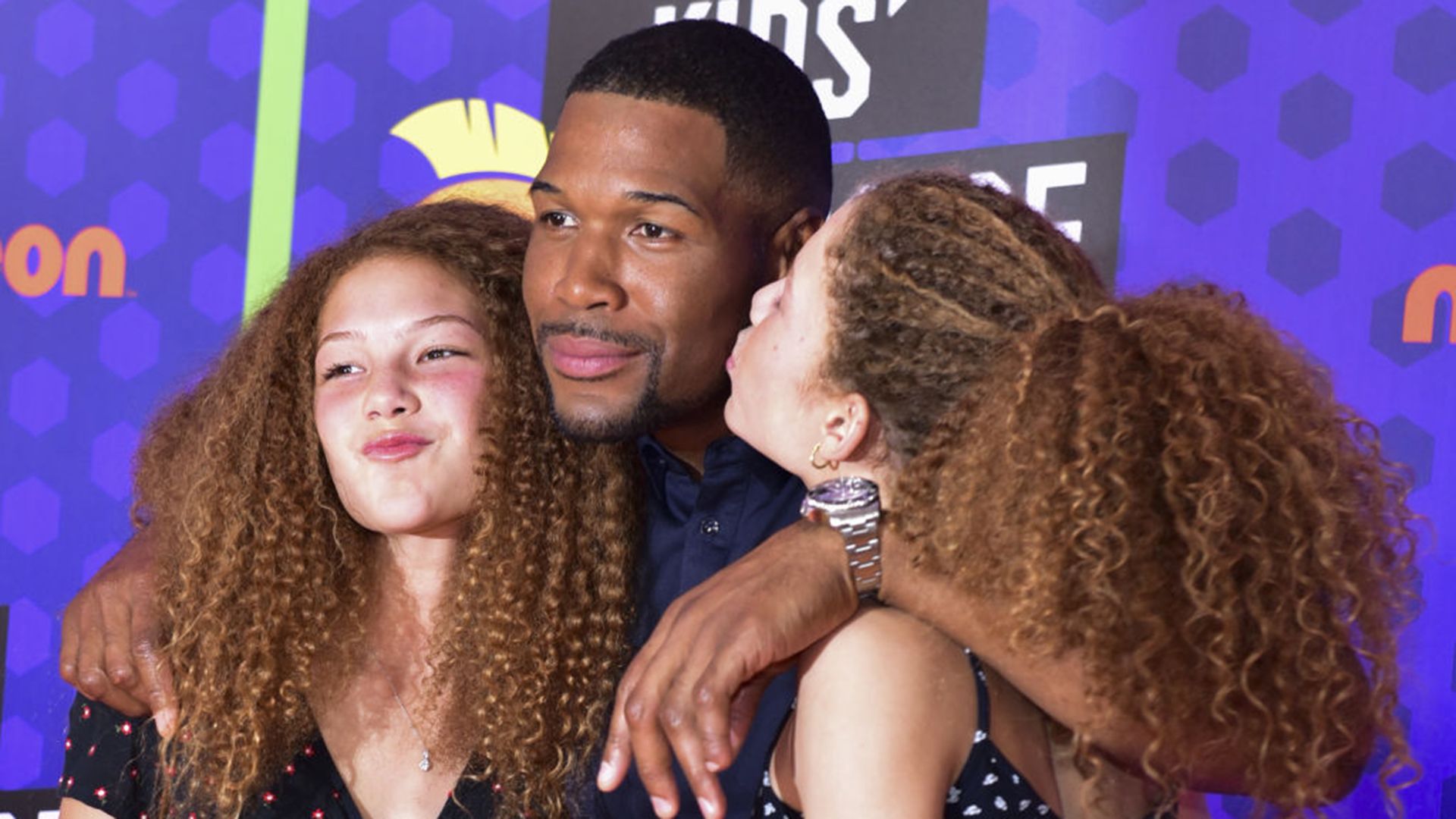 Michael Strahan poses with twin daughters Sophia and Isabella