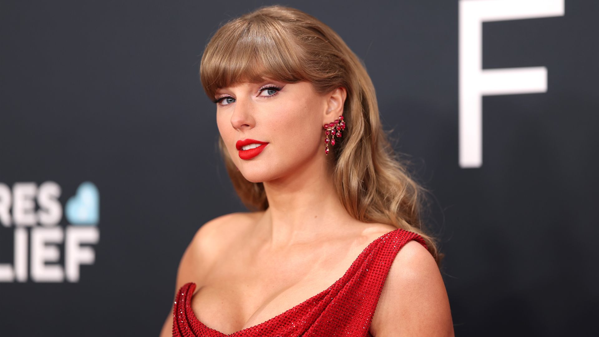 Taylor Swift's red-hot sculpted mini dress is a masterclass in festive dressing